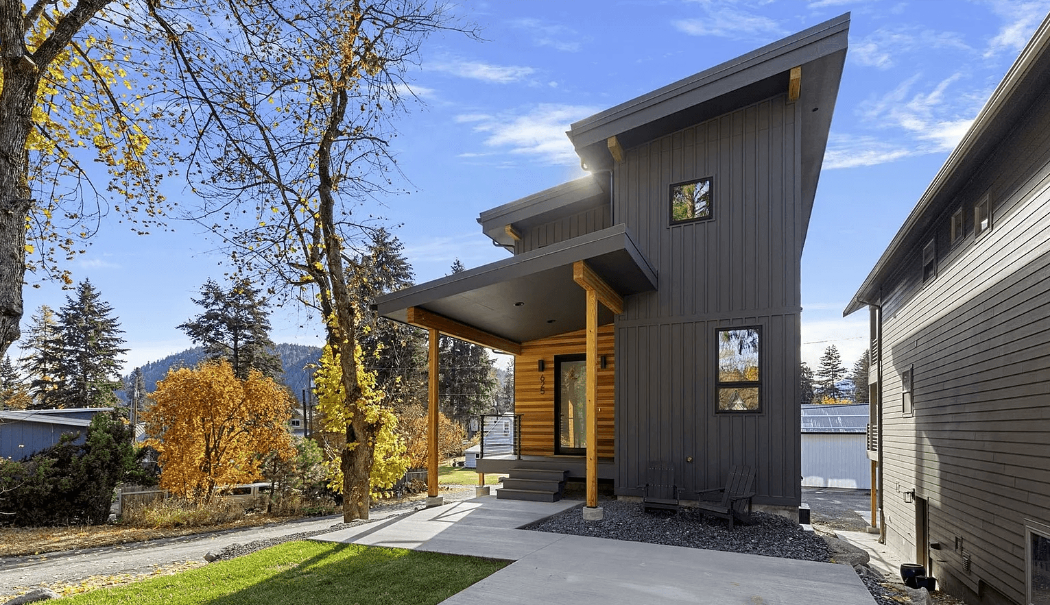 Exterior front profile of modern home with wood accents and large windows.