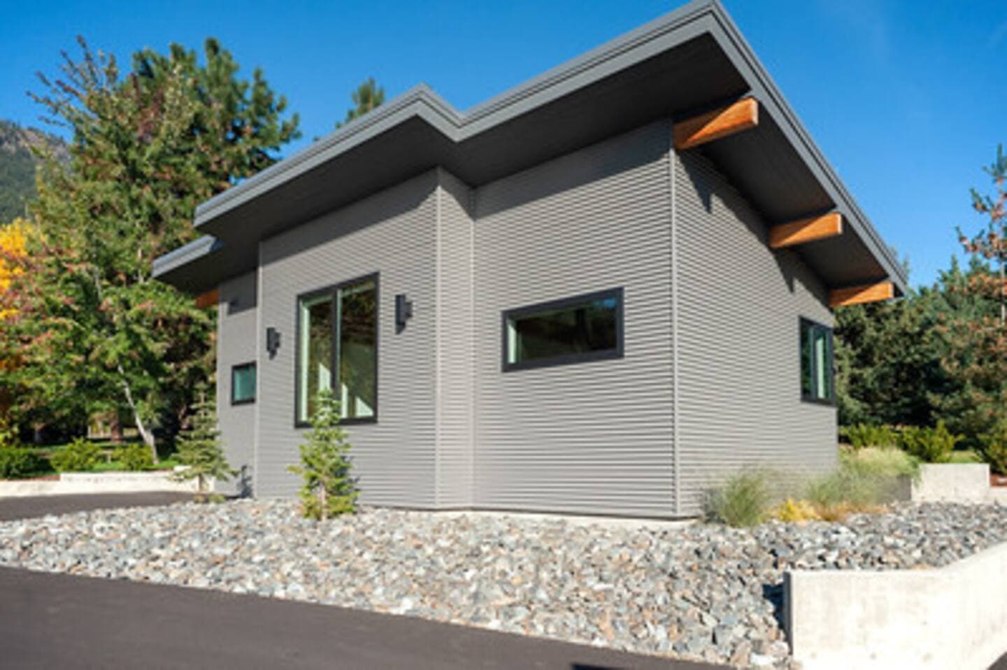 Front exterior profile of modern detached accessory dwelling unit with metal siding and wooden accents